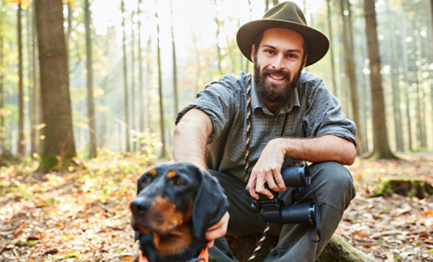 Jagdhaftpflichtversicherung: Jäger mit Hund im Wald