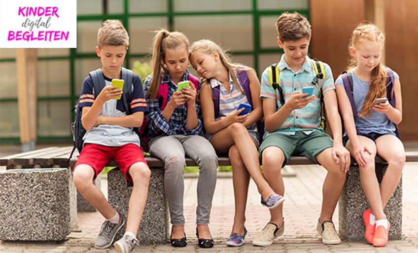 Kinder digital begleiten - Mehrere Kinder sitzen mit Smartphones auf einer Bank